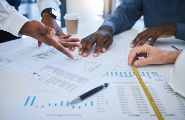 istock Hands, team and planning with an architect, engineer and designer meeting and in discussion over a construction document. Teamwork, building and collaboration with a contractor group for architecture 1434892104