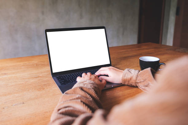 istock Mockup image of a woman using and typing on laptop computer with blank white desktop screen 1434893910