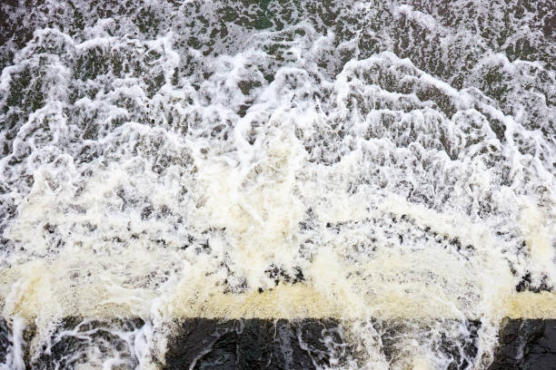 istock Foamed water top view with bubbles. Water foam waterfall threshold abstract background texture. Waves surface closeup. 1434894317