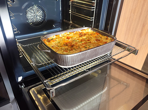 Homemade lasagna in a transparent glass form cooked in the oven on home cuisine. Mediterranean italian food
