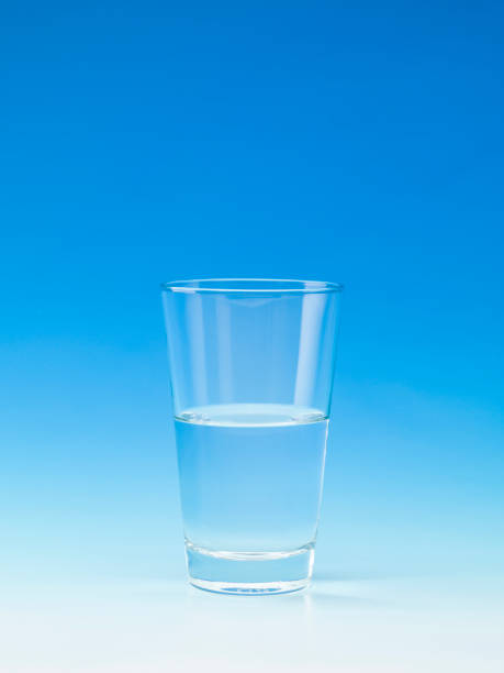 water in a glass on blue background