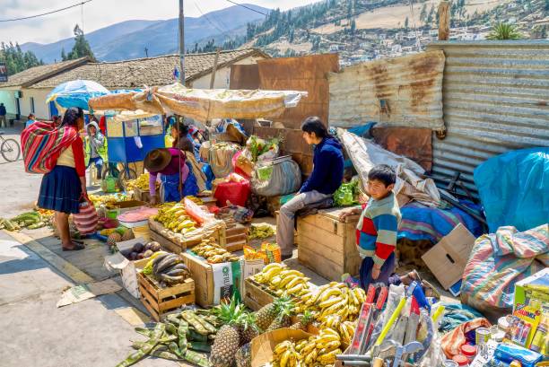 Local people making a living and shopping at a small outdoor market in rural Peru. stock photo