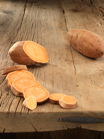 Chopped sweet potatoes on wooden table