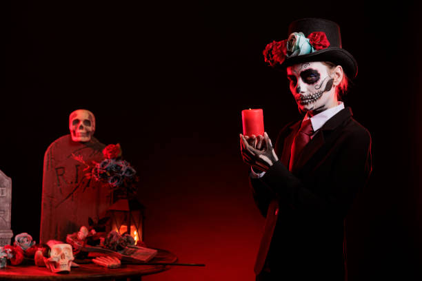 istock Beautiful model with skull make up holding candle burning 1434905674