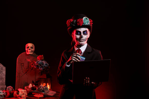 istock Young adult doing online shopping with skull make up 1434905697