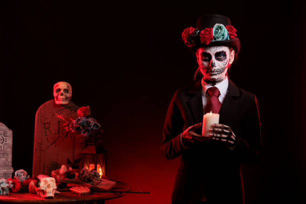 istock Young woman with skull make up holding candle burning 1434905733