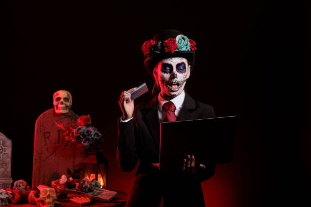 istock Creepy person doing online shopping with skull make up 1434905946