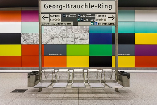 Munich, Germany – June 06, 2018: The Metro station seats with a colorful wall in the background in Georg-Brauchle-Ring station, Munich, Germany