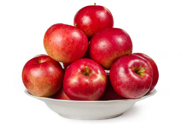 istock Lots of red apples in a plate on a white background. 1434907239