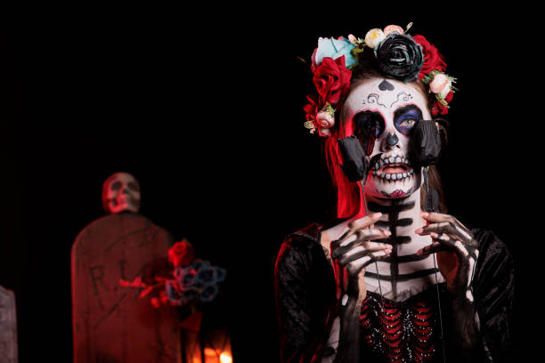 istock Creepy santa muerte model posing with black roses 1434908898