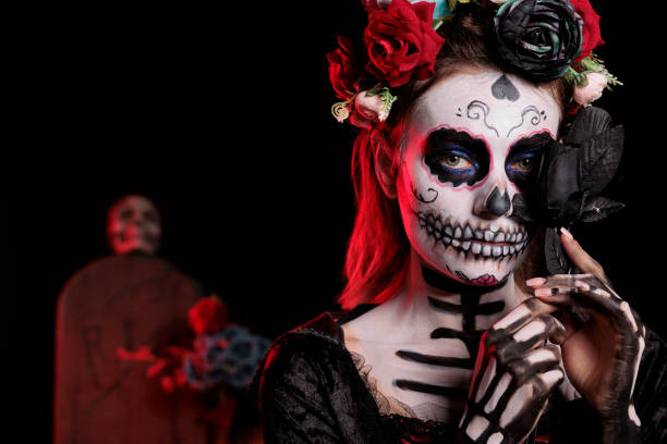 istock Spooky santa muerte lady posing with black roses 1434909533