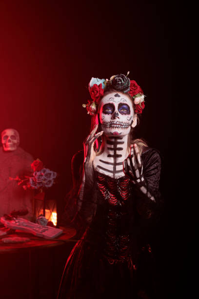 istock Santa muerte model talking on mobile phone call 1434910046