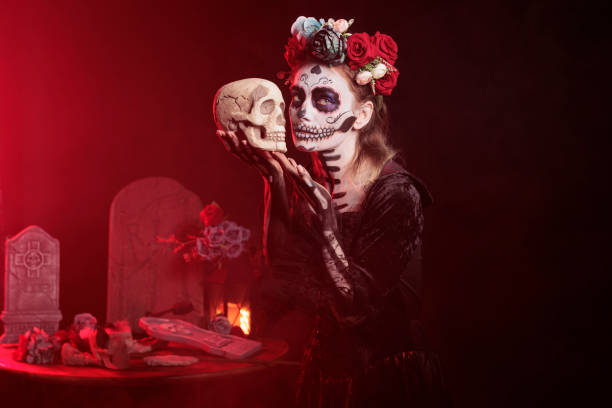 istock Santa muerte model holding skull in studio 1434910392