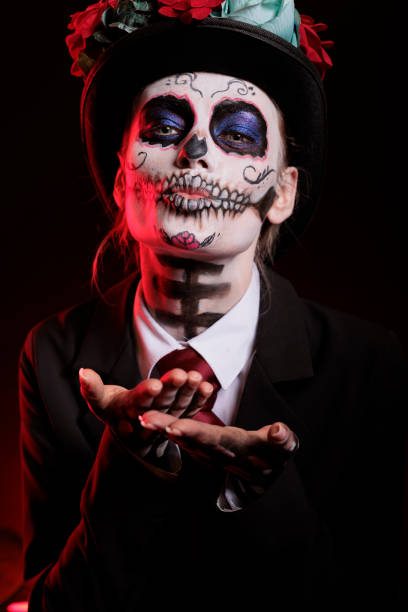 istock Woman doing kissy face with santa muerte make up 1434910439