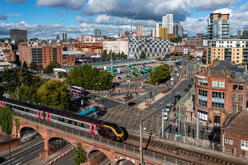 Leeds, UK - September 28, 2022. Aerial panorama view of Leeds city centre with bus station and a Cross Country Train providing transport for travellers