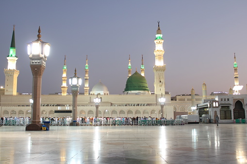 Beautiful morning view of Masjid Al Nabawi, Medina's green dome, minarets and mosque courtyard.