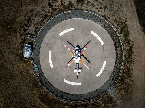 A helicopter in the middle of a circle parking, top view