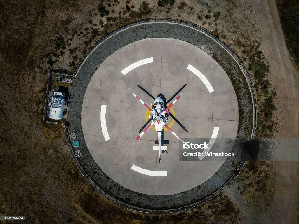 Helicopter in the middle of a circle parking, top view A helicopter in the middle of a circle parking, top view Drone Stock Photo