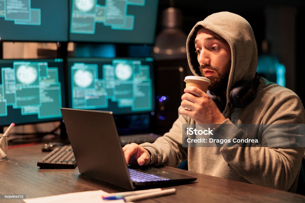 IT programming thief hacking computer system IT programming thief hacking computer system in office, drinking cup of coffee and acting dangerous. Stealing information from big data software, breaking security server with virus and code. Adults Only Stock Photo IT programming thief hacking computer system IT programming thief hacking computer system in office, drinking cup of coffee and acting dangerous. Stealing information from big data software, breaking security server with virus and code. Adults Only Stock Photo