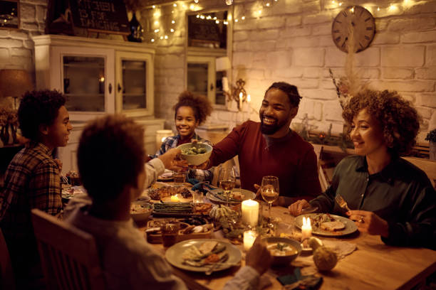 istock Happy black man having Thanksgiving dinner with his extended family at dining table. 1434916582