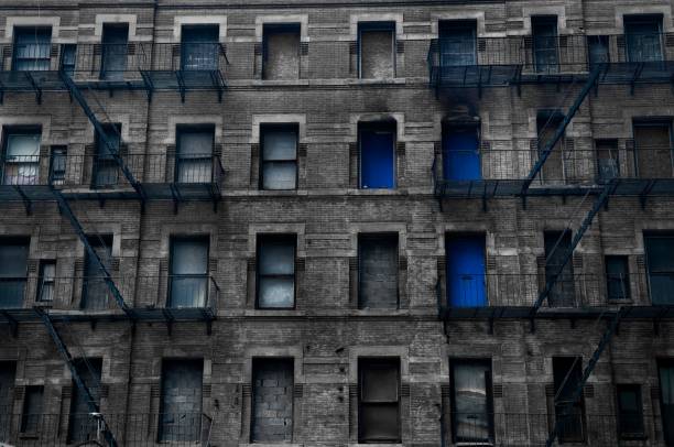 istock Stony building facade with balconies and blocked windows in New York 1434917067