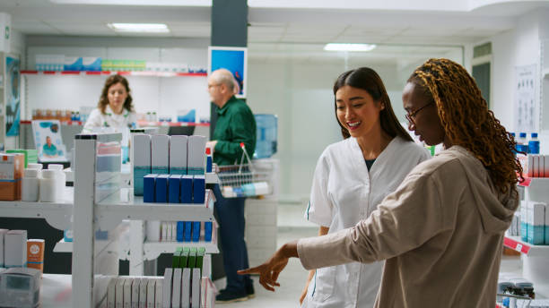 istock Asian pharmacist talking to diverse customers with disease 1434920783