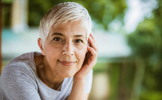 Portrait of smiling mature woman looking at camera. Copy space.
