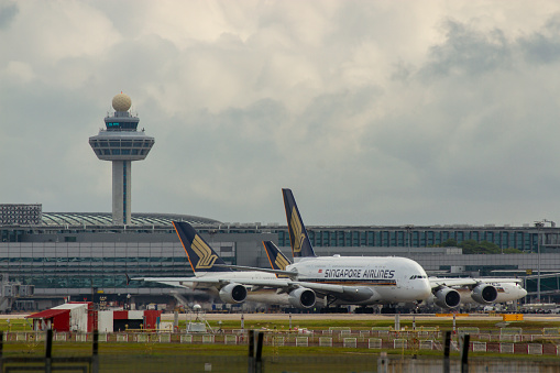 Changi, Singapore - ‎February 11, 2020 : Airplanes Of Singapore Airlines At Changi International Airport With Air Traffic Control Tower.