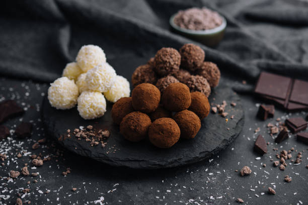 three types of chocolate balls on stone board