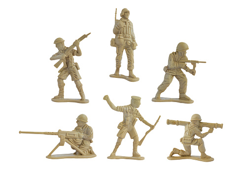 Collection of miniature toy soldiers with guns isolated on white background. Toy plastic soldiers for young kid.