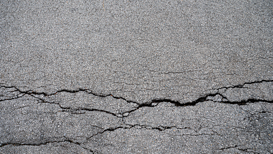 Cracks or splits on the road surface. Damaged asphalt roads
