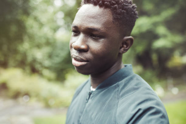 istock Young African American man in bomber jacket in park. Fall or spring season 1434929546