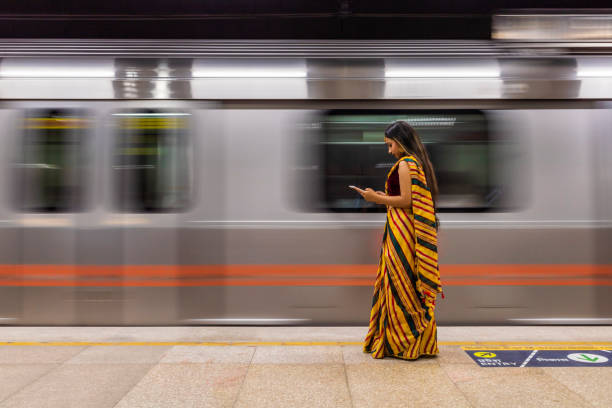 indisches mädchen mit einem digitalen tablet an der u-bahn-station, indien - train subway station people subway train stock-fotos und bilder