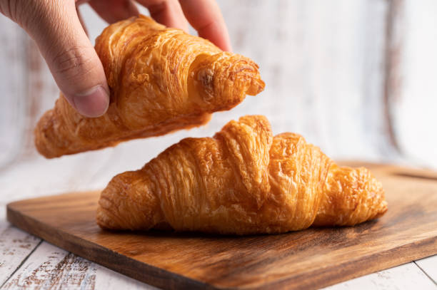 Croissants on a wooden cutting board. Selective focus. stock photo