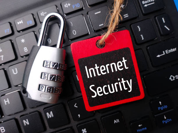 istock Padlock and wooden board with the word Internet Security on a wireless keyboard. 1434932443