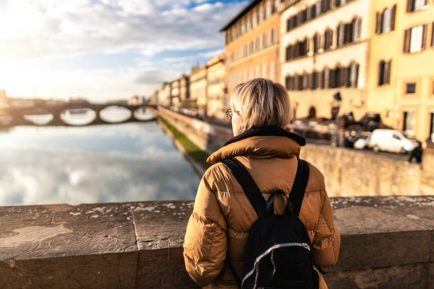 istock Tourist watching Arno river at sunset 1434933662