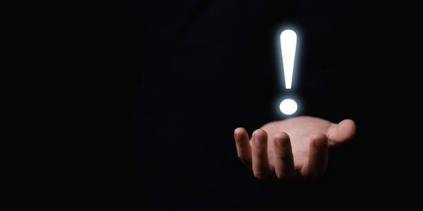 istock The businessman's hand shows a white exclamation mark. business development concept, error warning, notification, maintenance, and finding a solution. dark background with copy space 1434935858