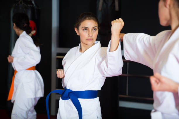 istock Women fighting during group karate training in gym 1434936188