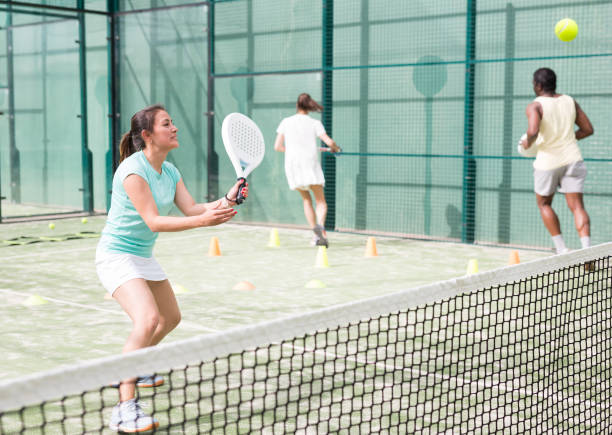 istock Training while playing on tennis court. Woman learning to play paddle 1434936193