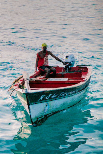 Fisherman arriving at the local pier on a fishing boat.