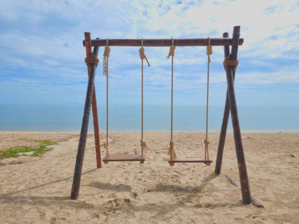 istock Romantic swings in Samila beach Thailand watching in the morning 1434940323