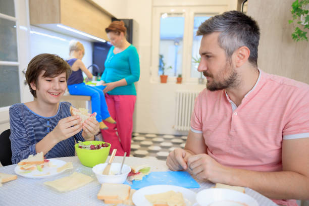 istock Family of four having breakfast, morning routine in the kitchen 1434942388