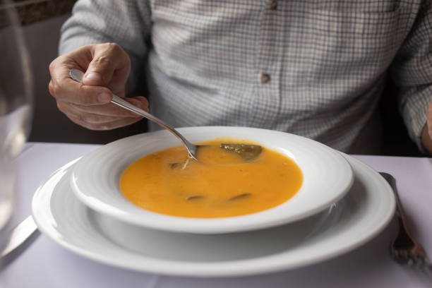 istock man eating vegetable soup in the restaurante 1434943146