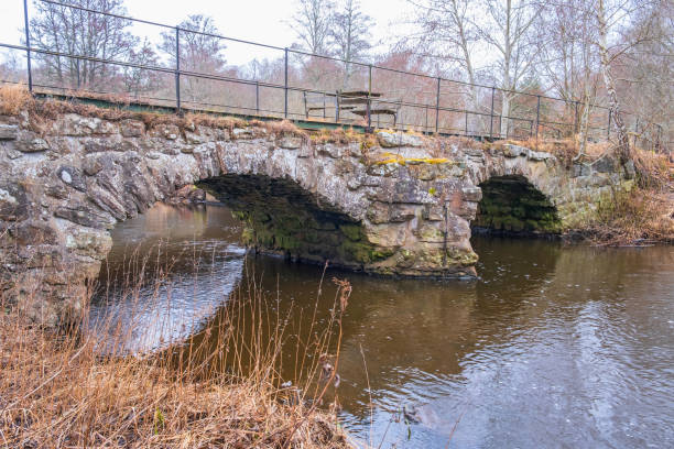 istock Ols stone bridge by a stream in the spring 1434943676