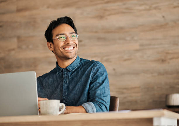 istock Cafe, laptop and happy Asian man remote work thinking while typing email in restaurant. Young calm entrepreneur work on digital device, use intenet technology for business reports and copywriting 1434944971