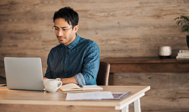 istock Laptop, design and marketing with a creative business man and nerd working on a computer in his office. Email, internet and creativity with a male employee at work in his modern advertising agency 1434944972