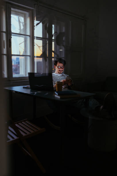 istock Young businessman with a smiling face using his phone in the office 1434945940