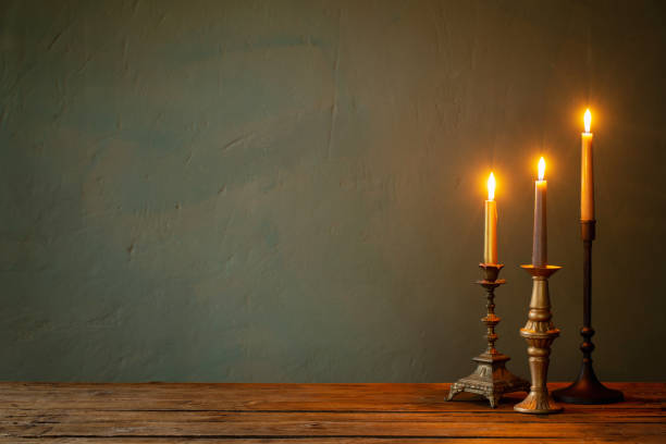 istock burning candles in vintage candlesticks on dark background 1434946144