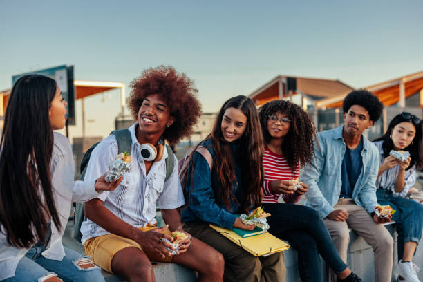 istock Happy students eating lunch together. 1434948105