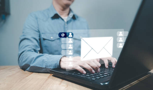 istock email marketing concept, send e-mail or news letter, online working internet network.Businessman hands using Laptop typing on keyboard and surfing the internet on office table with email icon. 1434948603